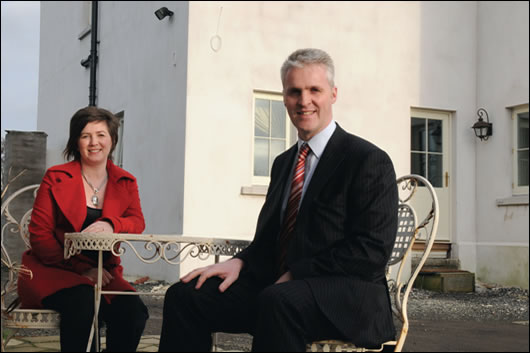 The clients, Neil and Kyra Orr, relaxing in their front courtyard, are able to reflect on a job well done