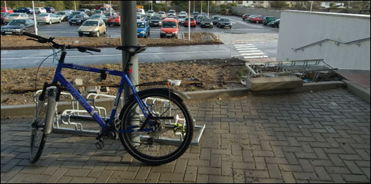 A solitary bicycle reveals the extent of the environmental challenge in terms of affecting behavioural change. As with the car parks, the bicycle parking area is paved with Aquapave, a sustainable drainage product.  
