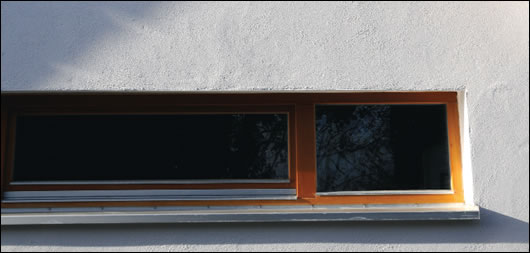  sun light illuminates the timber of the roof overhang