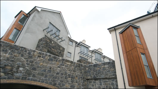 The black limestone that caused so much trouble at the early stage of the build has been extensively reused as facing material throughout the development