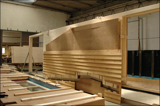 A large wall panel in the Riko factory displaying its wood fibre insulated interior