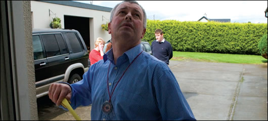 Energy assessor Stephen Harte, measuring a house in Tipperary during the Home Energy Saving scheme pilot