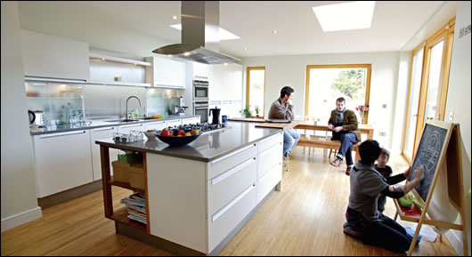 Javier Monedero, architect Paul McNally, Siobhan Egan and daughter relax in the renovated kitchen