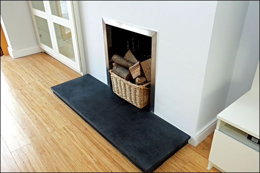 Sustainably-sourced bamboo flooring was used throughout and adds colour to the interior, while the carbon logs that adorn the fireplace will remain sequestered – the chimney has been closed to reduce heat loss and cold air penetration