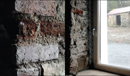 (left) The large stone walls of the house provide good thermal mass; (right) the house’s windows are all triple-glazed units supplied by Optiwin