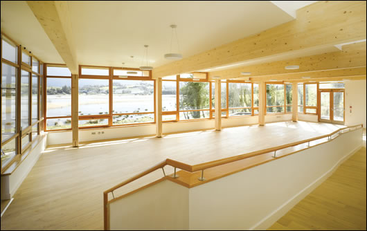 an extensively glazed wall lets sunlight illuminate the south-facing café space while enabling staff and visitors to view the wetlands below