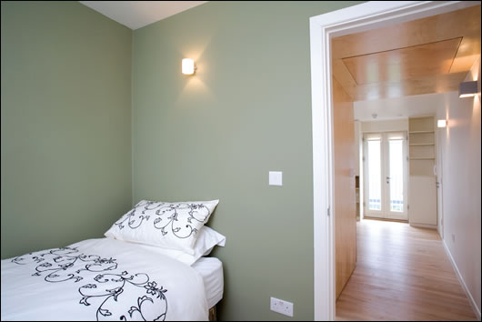 The house is divided into four 20 sq. m self-contained apartments, each featuring a bathroom, bedroom (above) and kitchen-cumliving room (below). Designing the building so four people could live comfortably in four separate apartments was one of the key challenges for architect John-Barry Lowe;