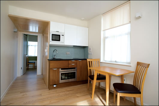 The house is divided into four 20 sq. m self-contained apartments, each featuring a bathroom, bedroom (above) and kitchen-cumliving room (below). Designing the building so four people could live comfortably in four separate apartments was one of the key challenges for architect John-Barry Lowe;