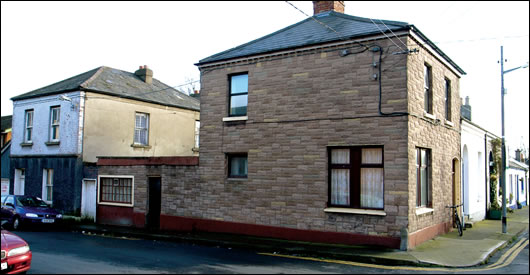 The existing building, clad in unsightly brown tiles, before it was demolished. 