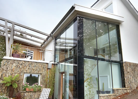 Locally sourced stone was used for external cladding and a garden wall