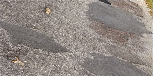 Due to decreased revenue, county councils have taken to filling-in potholes instead of resurfacing the road