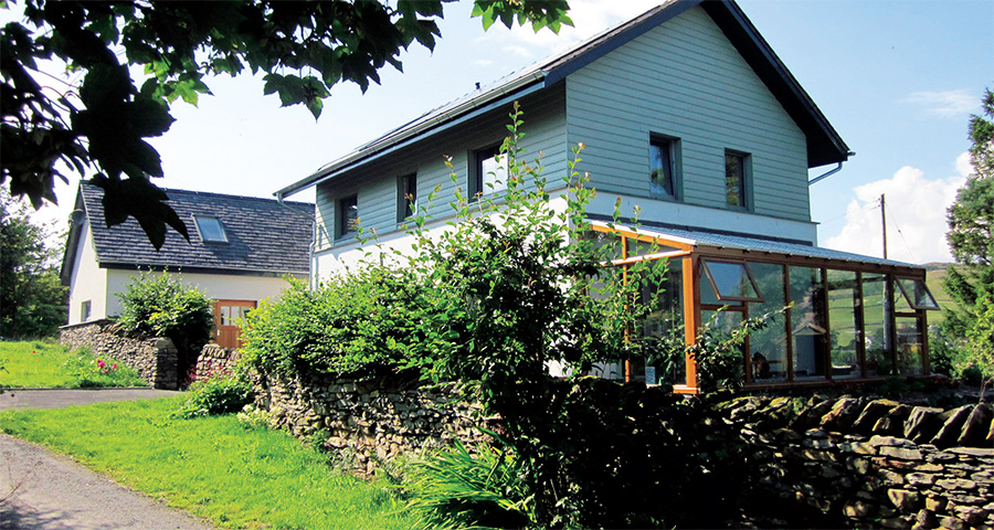 The house is clad with silicone render on the ground floor and Eternit Cedral weather board on the first floor;