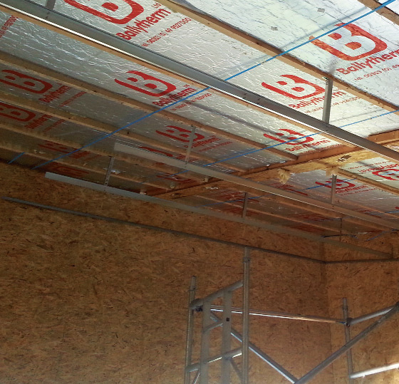 OSB encases the wall insulation and a suspended ceiling system house with 300mm depth to take a Rockwool layer