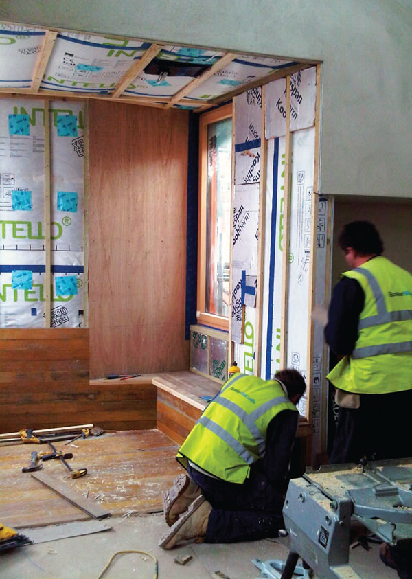 fitting the reclaimed maple lining to the top floor dormer window