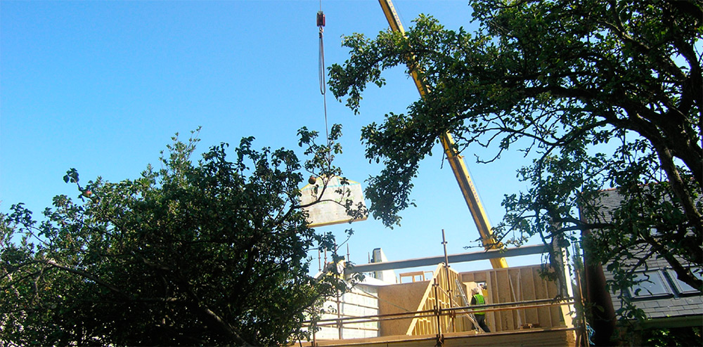 Erection of the timber frame, with the gable panel craned into place