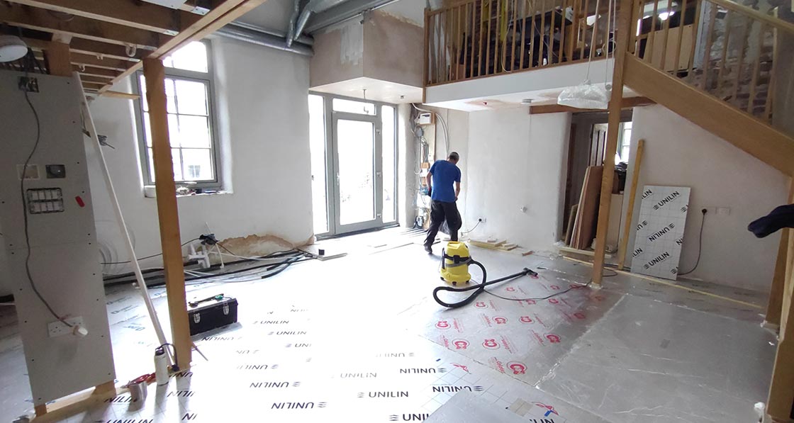 Floor insulation including some Unilin and salvaged (fly-tipped) Celotex rigid insulation used for a floating floor, and Phonotherm load-bearing pads beneath the stud walls and staircase.