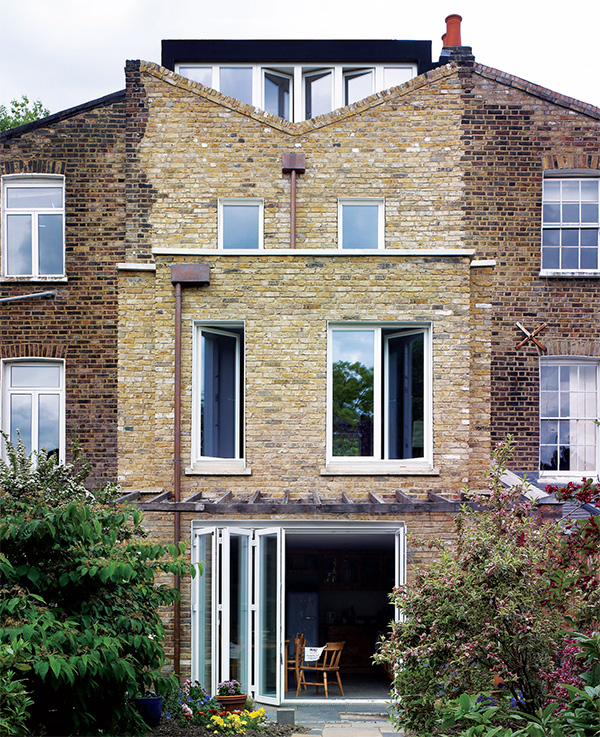 The new rear facade features timber-framed windows with triple-glazing