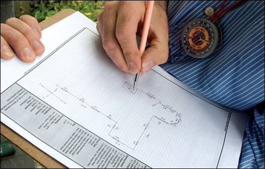 Stephen Harte drawing a map of the house: note the compass for checking orientation