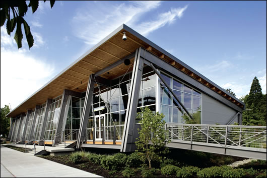 The Pavilion in the Park at South Lake Union, Seattle separates at three integrated joints to break into four separate modules. The building sits lightly atop short concrete piers allowing the grade and vegetation to run uninterrupted beneath. Gangway ramps with integrated hinged joints can adapt to the topography of future locations