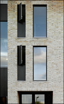 The new buildings are fitted with double-glazed windows that boast a U-value of 1.5 W/m2K for the overall unit. Glazed sections cannot be opened, but accompanying timber panels can