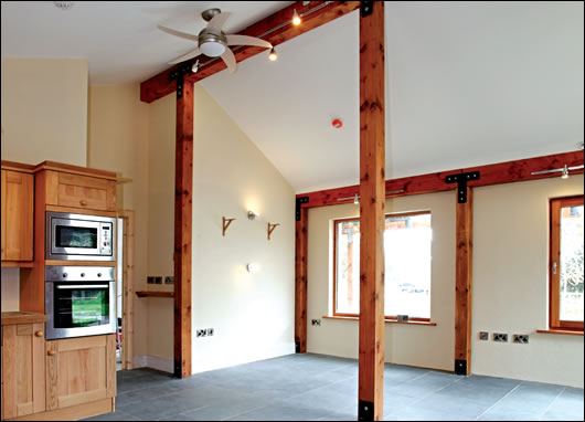 the main post and beam structure, seen here in the kitchen-cum-living room, is locally sourced douglas fir