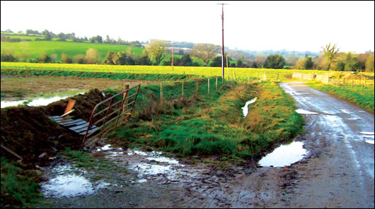 The ends of the percolation pipes within the flooded percolation area to the left extend into a surface water ditch which runs directly into a small water course about 40m away, resulting in a sewage fungus growth in the stream.