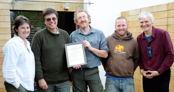 (left to right) Architect Janet Cotterell &amp; client Adam Dadeby receive the passive house certificate from builder Jonathan Williams, pictured with build team member Joe Bellows with passive house certifier Peter Warm